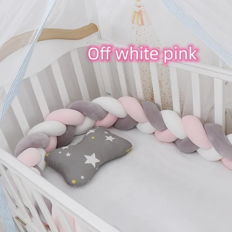 Braided knot pillow cushion bumper for infant crib in spandex velvet, shown in a light colour.