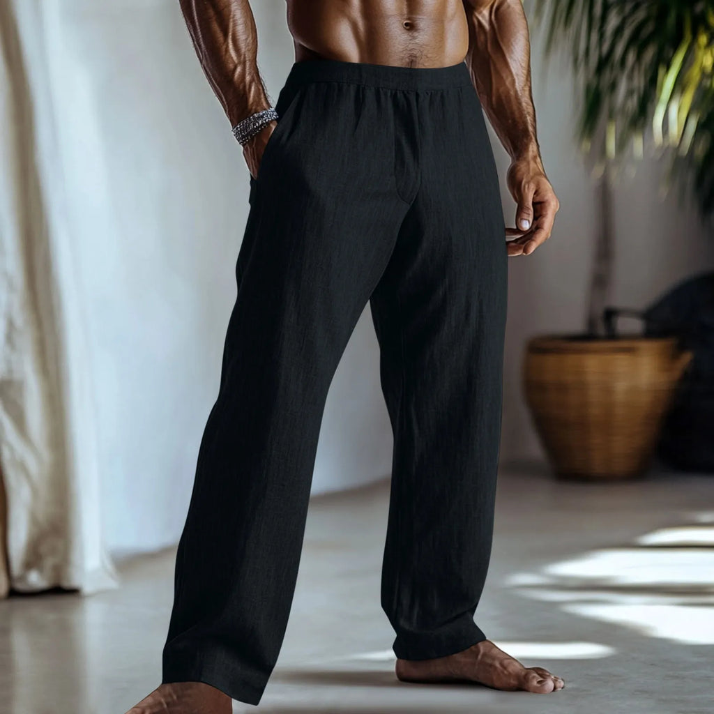 Straight leg cotton linen trousers in light apricot colour on a hanger.