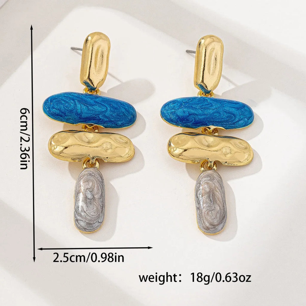 A pair of simple geometric stud earrings with a multicolour electroplated finish on a zinc alloy base.