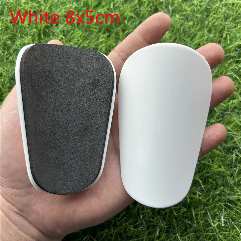 Pair of extra small black plastic football shin guards for junior players.