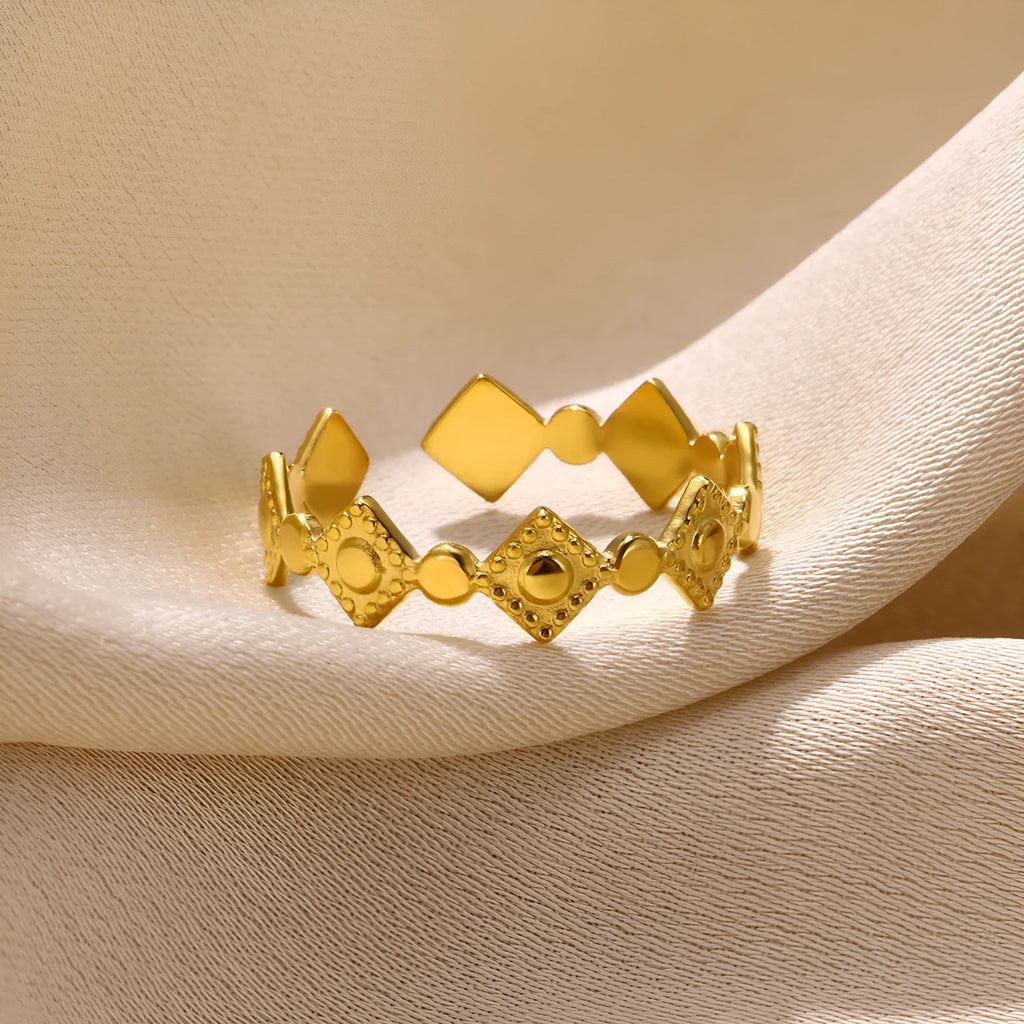 Gold geometric titanium steel ring with a diamond accent for women.