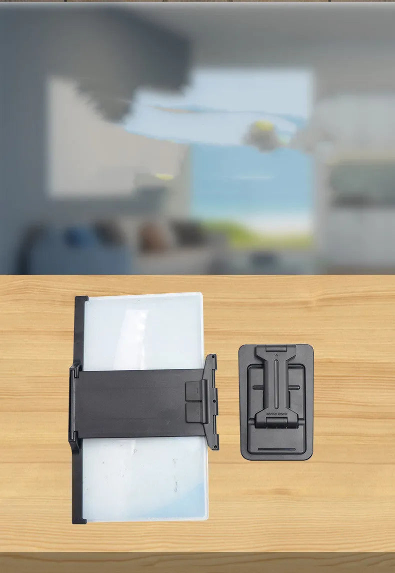 Black 12-inch mobile phone screen amplifier with detachable phone holder on desktop