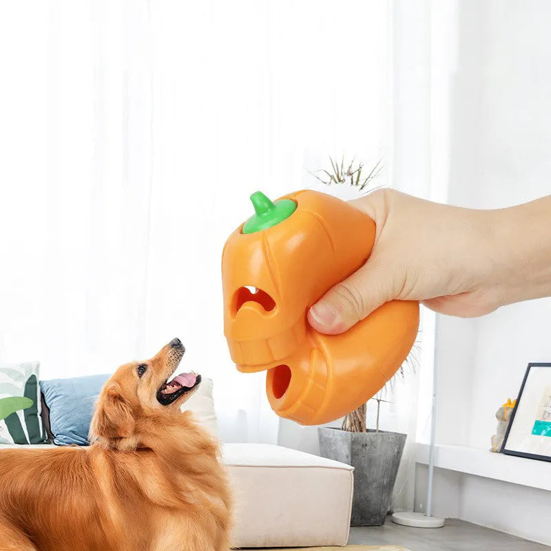 Orange Halloween pumpkin shaped dog chew toy made of durable rubber with a treat-dispensing funnel.