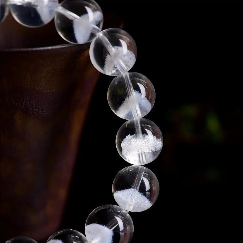 Women's white crystal pyramid bracelet with ghost detail and Ruyi design element