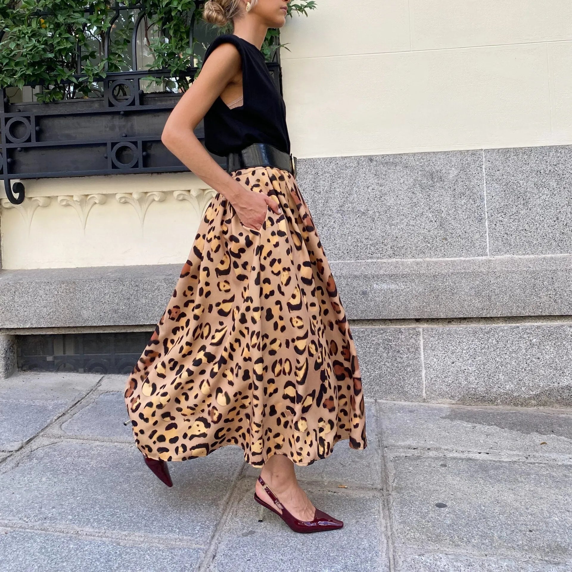 Brown leopard print women's A-line long skirt on hanger showing full length and animal pattern design