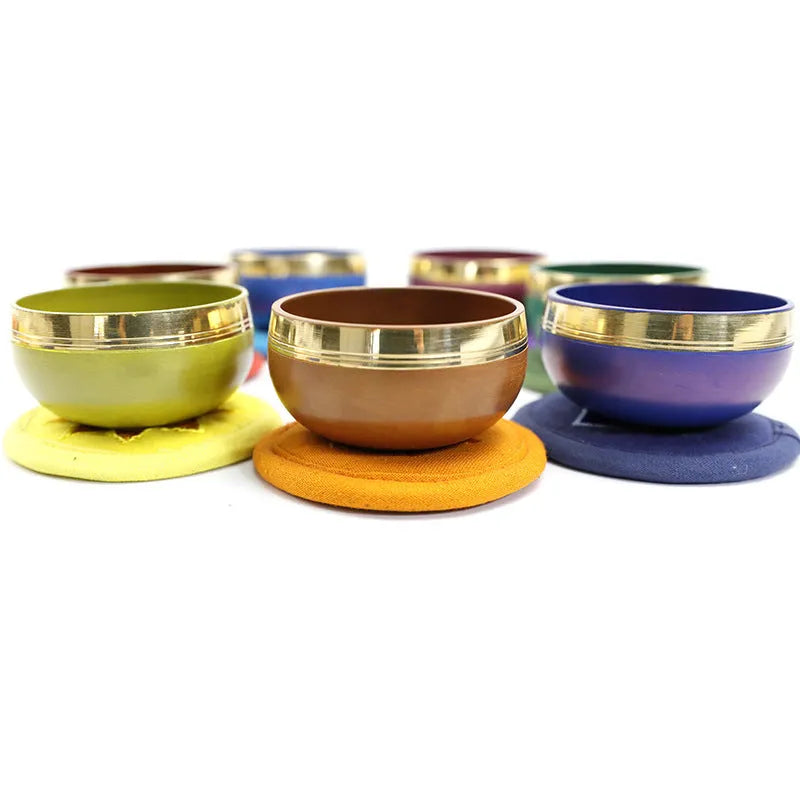 Seven colourful handmade Himalayan-style bowl percussion instruments arranged by size and colour