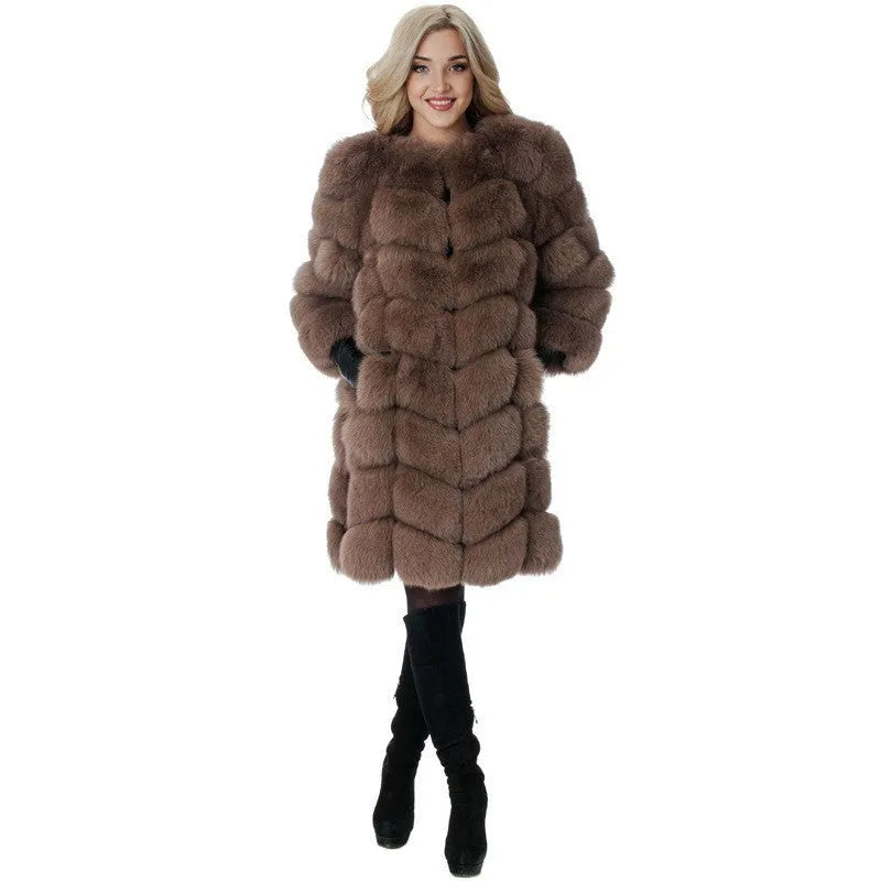 Women's thick black artificial fur coat with regular sleeves on a model.