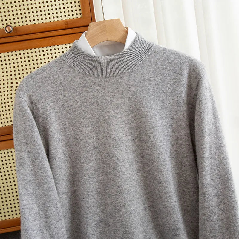 Man wearing a chunky knit half-turtleneck wool sweater in a loose fit.