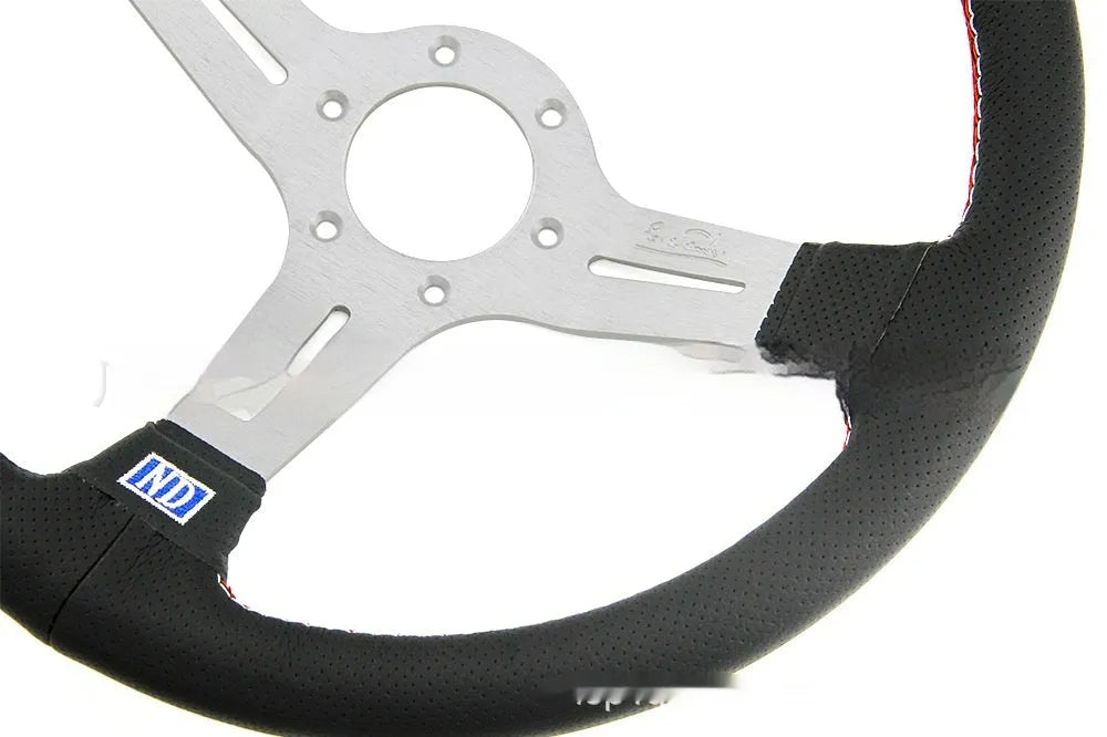 14-inch silver black leather steering wheel with concave centre grip and skeleton frame visible