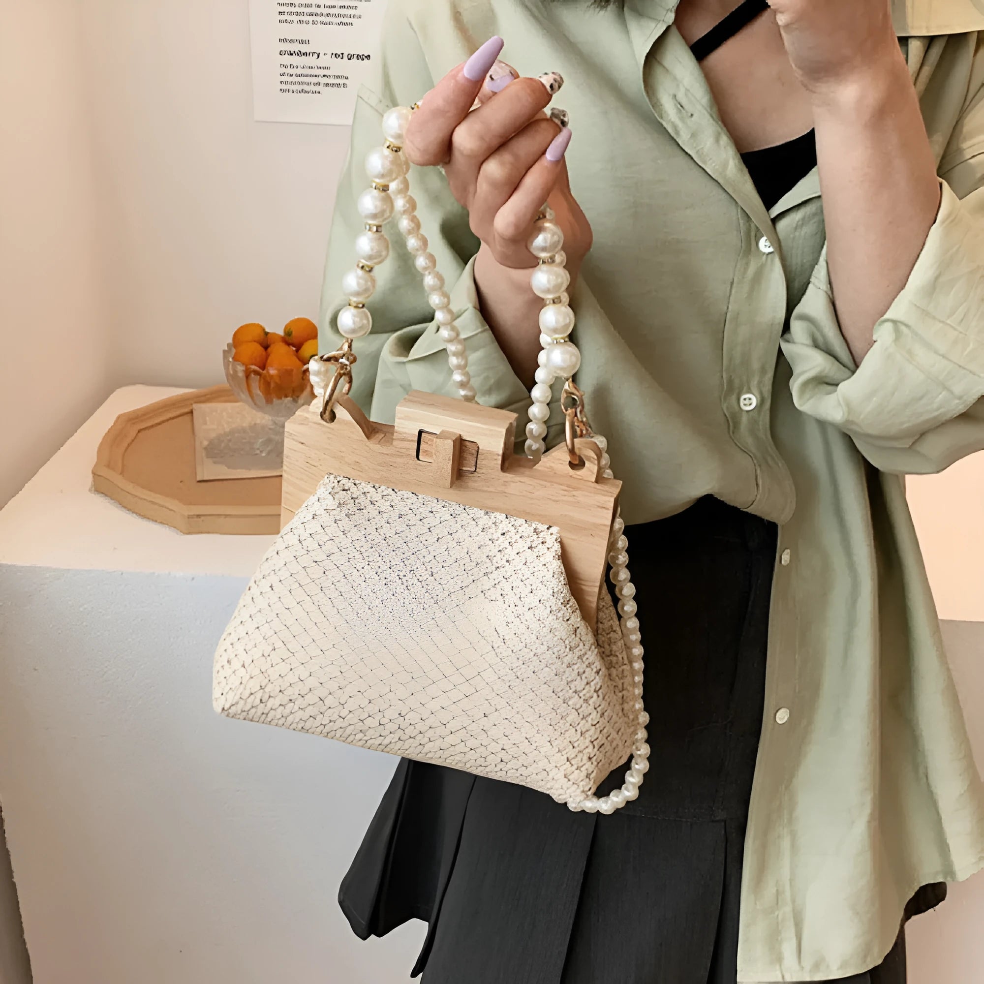 Women's straw woven shoulder bag with pearl chain detail in horizontal square shape