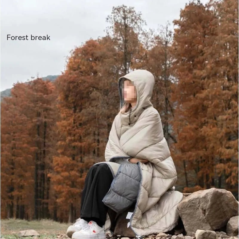 Adult-sized grey outdoor cloak sleeping bag with waterproof nylon exterior shown in wearable cape configuration