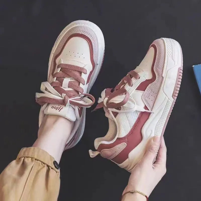 Beige and pink low-top sneakers with rubber soles and imitation leather lining