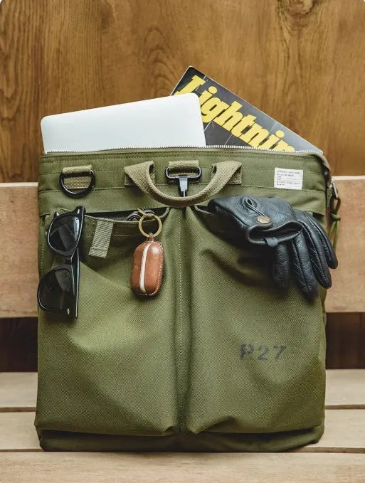 Retro canvas crossbody messenger bag in military green showing laptop compartment and phone storage