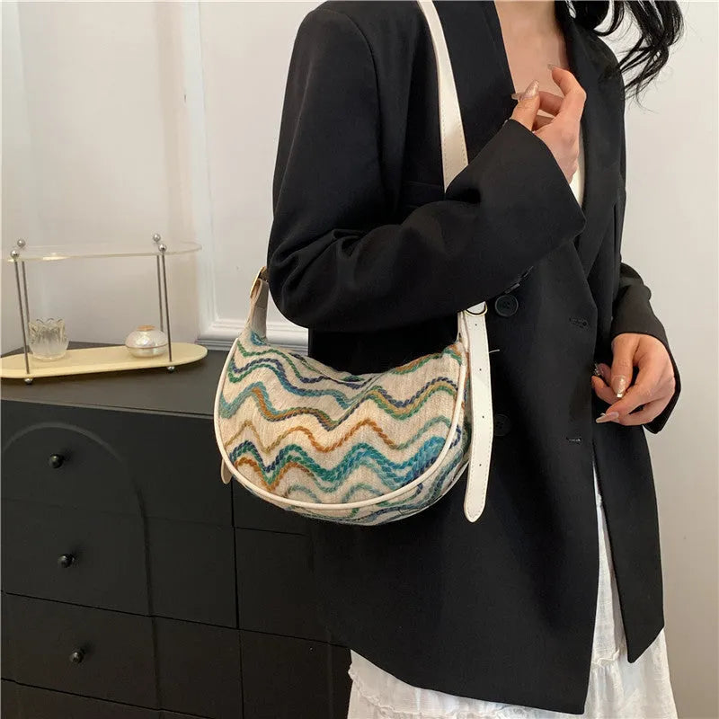 Women's straw woven crossbody bag showing woven texture and internal phone pocket