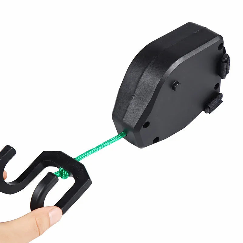Black plastic bicycle trailer rope connecting adult bike to child trailer for family cycling