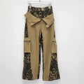 Dark khaki leopard print high waist jeans with tooling style stitching and straight leg cut