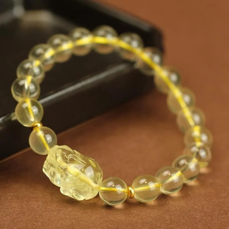 Yellow leather bracelet with a clear artificial crystal Pi Xiu charm.