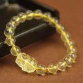 Yellow leather bracelet with a clear artificial crystal Pi Xiu charm.