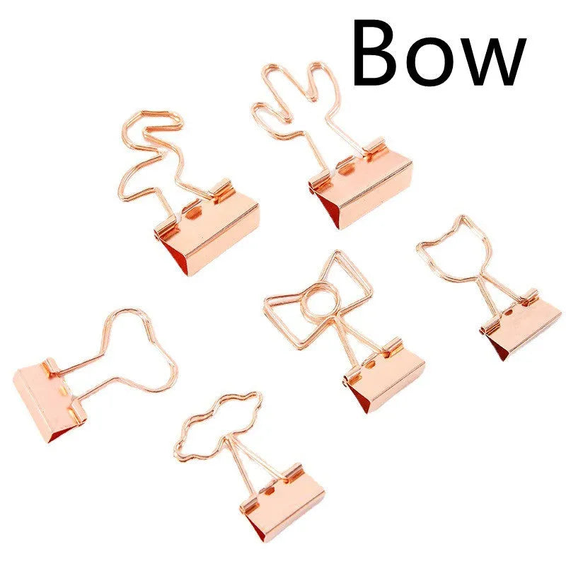 Gold metal paper clip with decorative shape options including bow, cactus, cat, flamingo, love, and clouds.