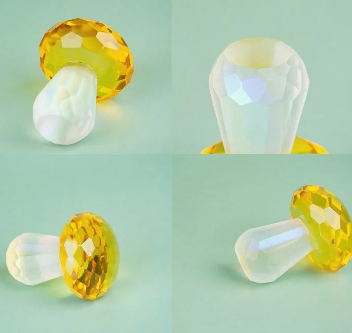 Colourful geometric crystal mushroom decoration in transparent, green, red, or yellow on a white background.