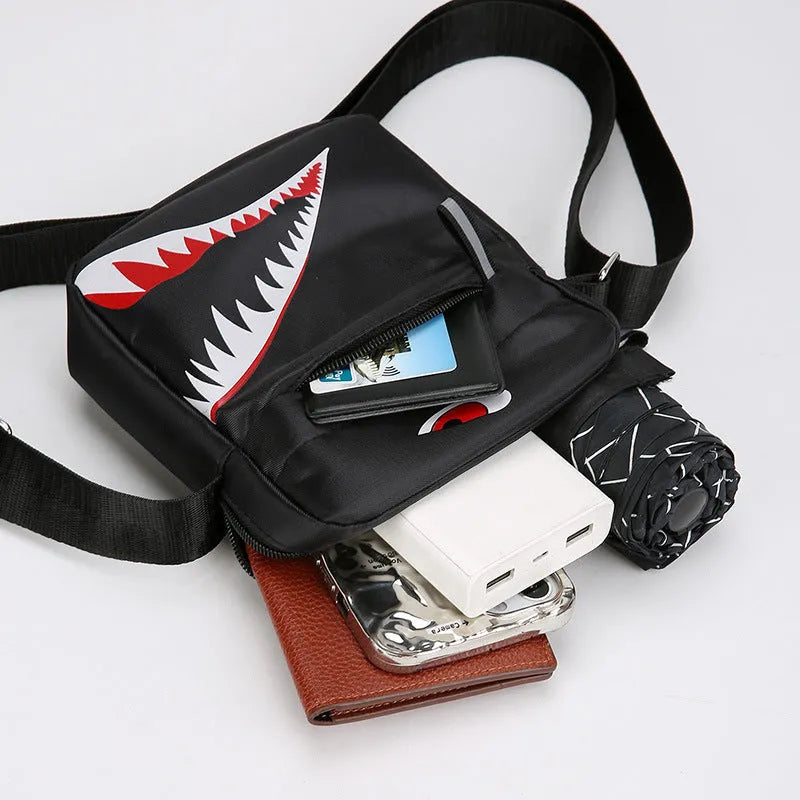 Men's black Oxford cloth crossbody bag with animal print pattern and shoulder strap.