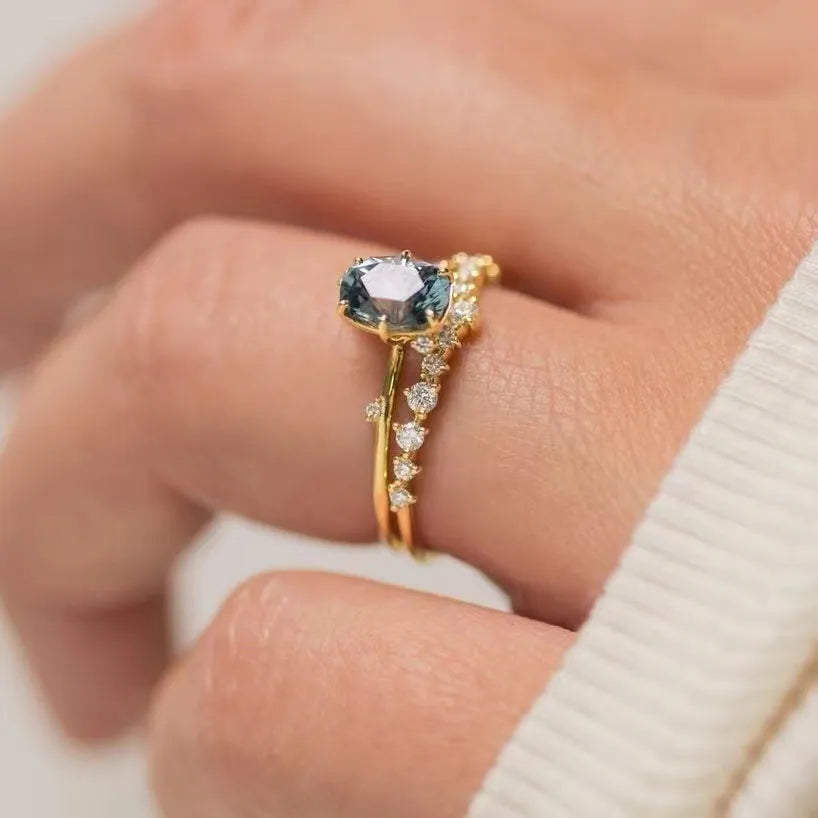 Gold-plated women's ring with flower shape and green zircon stone, shown as a pair.
