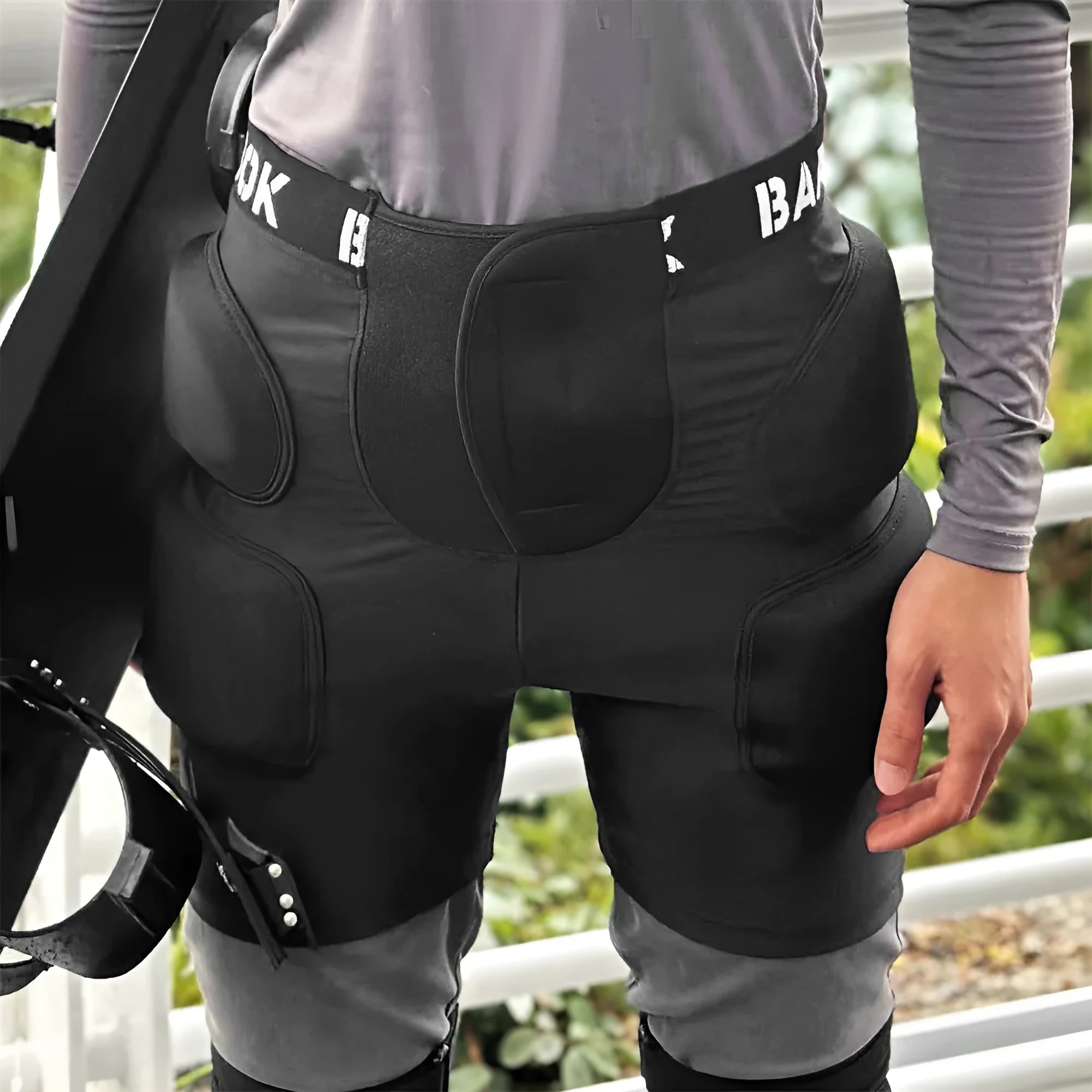 Black adult hip protection shorts with removable padding for skating and skiing safety.