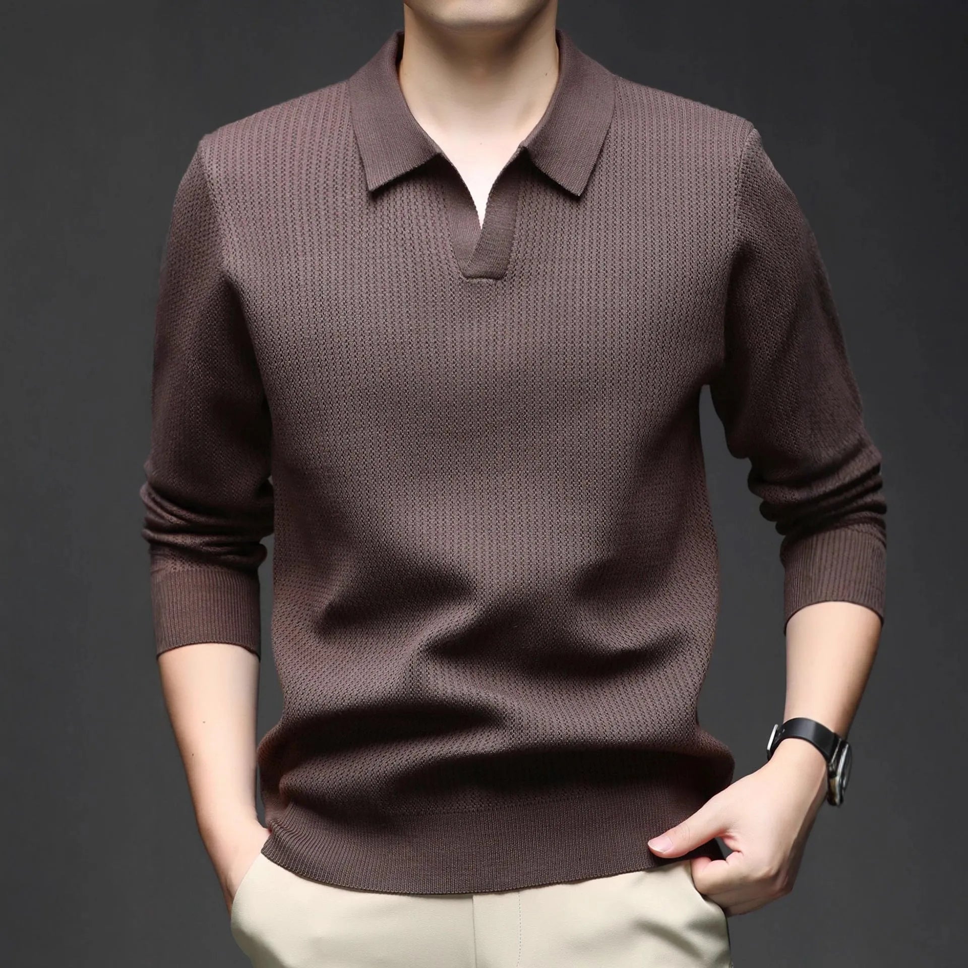 Man wearing a loose green pullover sweater, a casual autumn bottoming layer.
