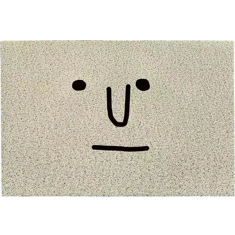 Square PVC floor mat with a large cartoon face Mr Big Nose design and geometric pattern on a grey background.