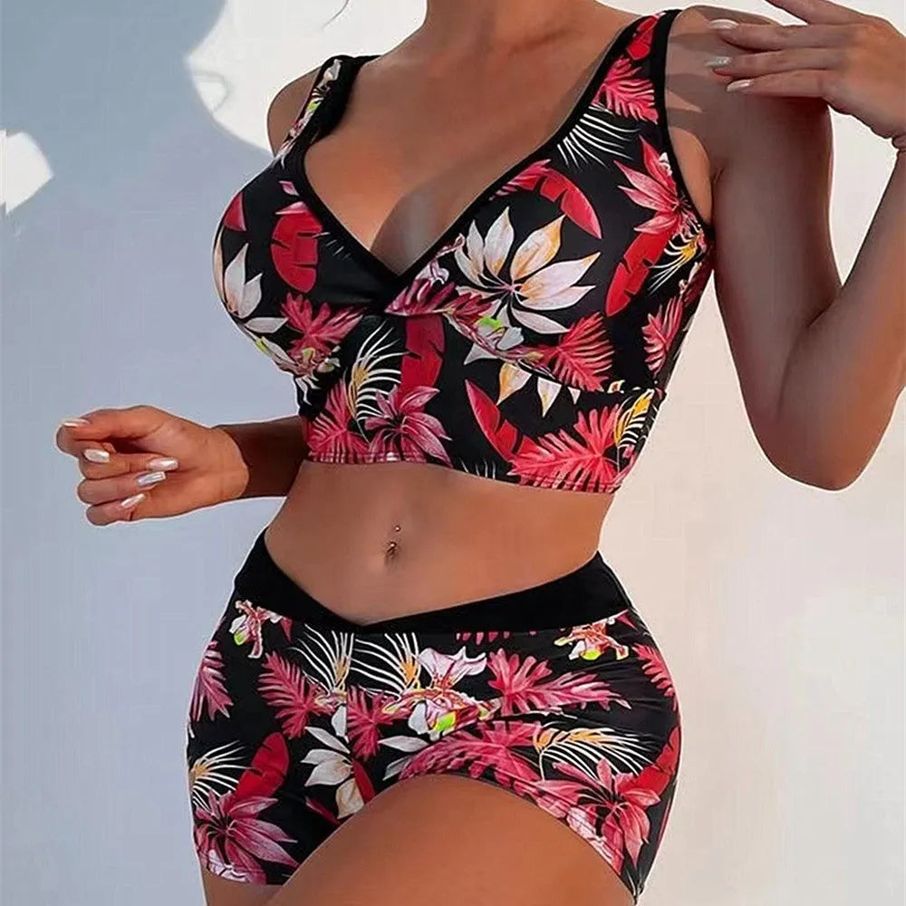 Women's two-piece swimsuit with sleeveless top and printed boxer brief bottoms in a multi-colour pattern.