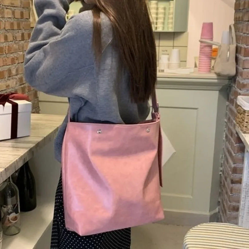Pink corduroy one-strap shoulder bag with PU lining, showing its 39cm length.