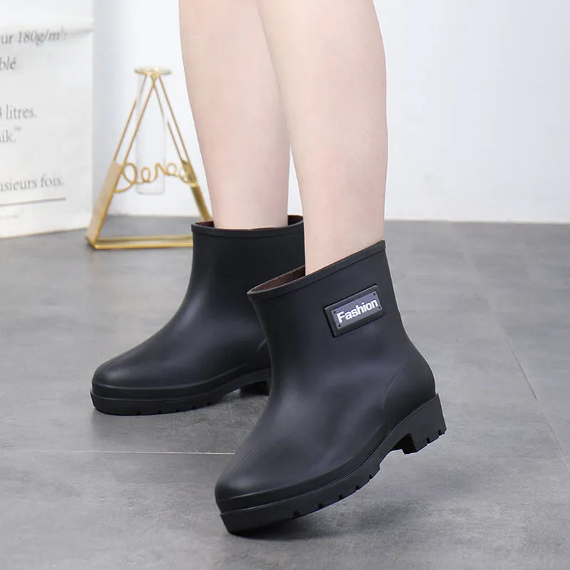 Women's mid-calf rain boot in PVC, low heel, shown in black colour.