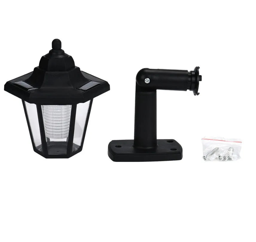 Black hexagonal solar-powered wall light with automatic sensor for outdoor garden or patio lighting