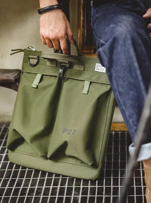 Retro canvas crossbody messenger bag in military green showing laptop compartment and phone storage