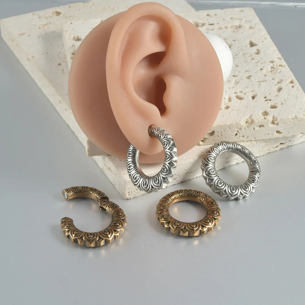 Geometric dragon shape stainless steel earrings in antique silver with hollow-out detail.