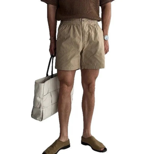Men's cotton sports shorts in loose fit style available in black, white, and khaki colours