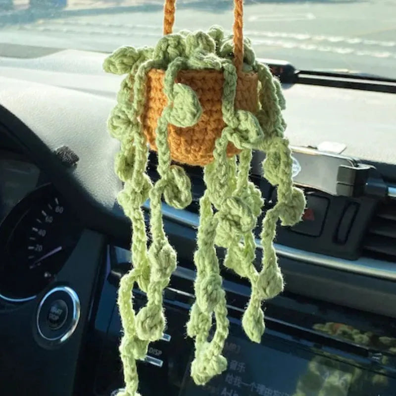 Green and white fish-scale style knitted wool car hanging planter with 8cm base and long white cord.