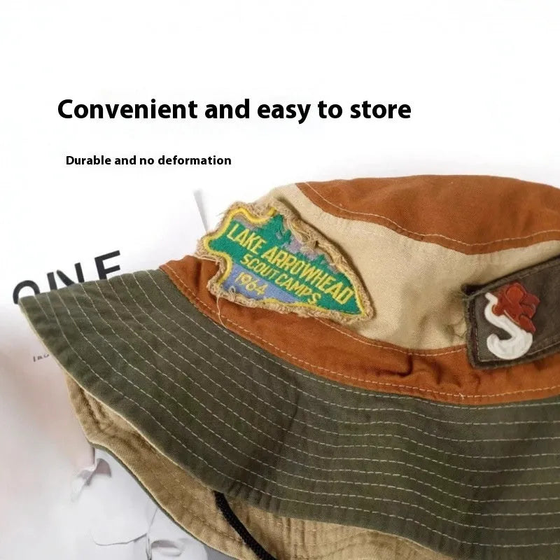 Army green cotton fisherman hat with flat crown and patchwork design folded for storage