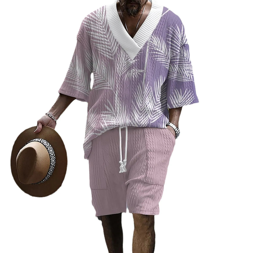 Man wearing a printed drop-shoulder knitted short-sleeve top and matching shorts in a casual setting.