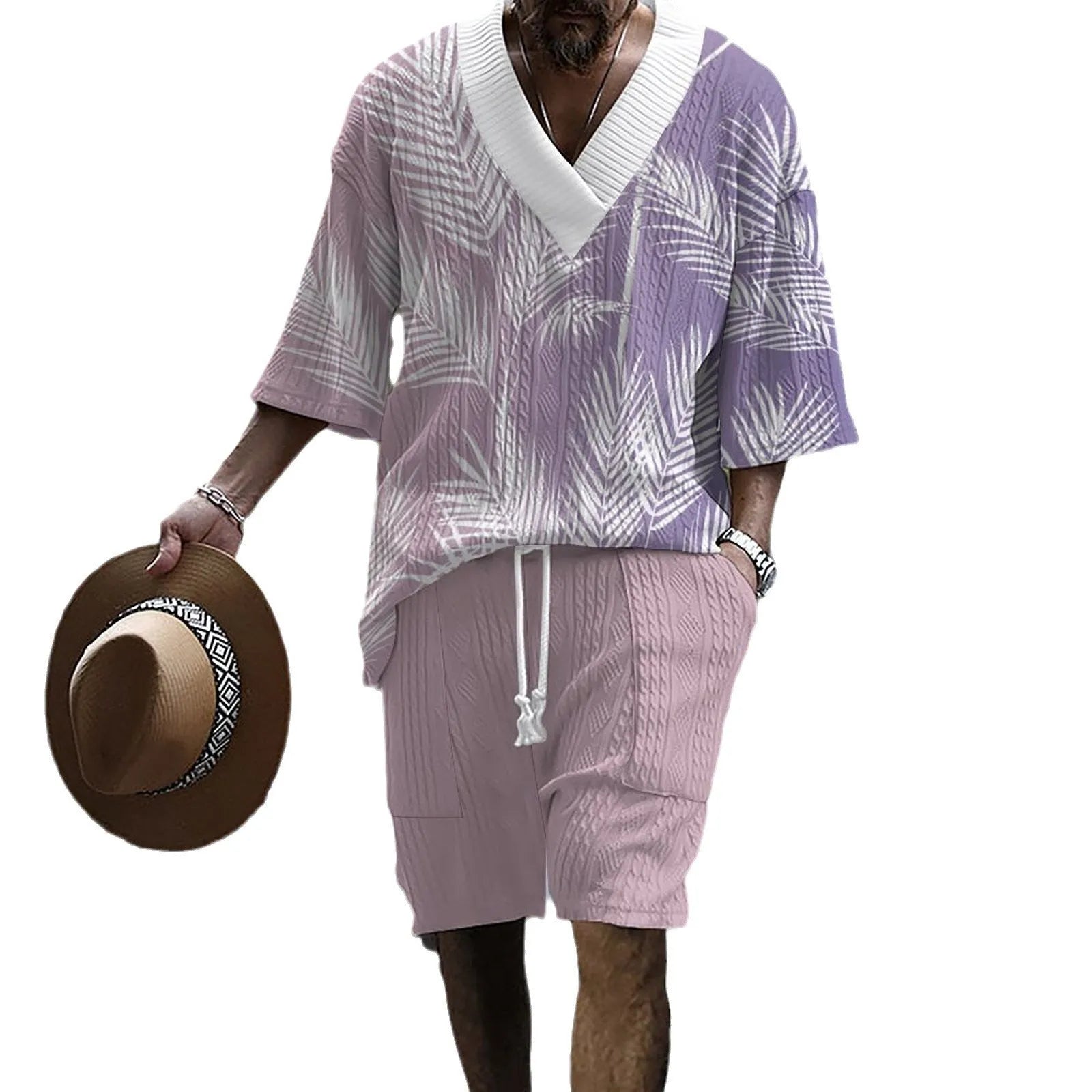Man wearing a printed drop-shoulder knitted short-sleeve top and matching shorts in a casual setting.