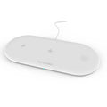 Black three-in-one wireless charging dock for iPhone, Apple Watch and wireless earbuds on a desk