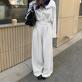 White striped wide-leg loose fit women's trousers with a zip fastening on a mannequin