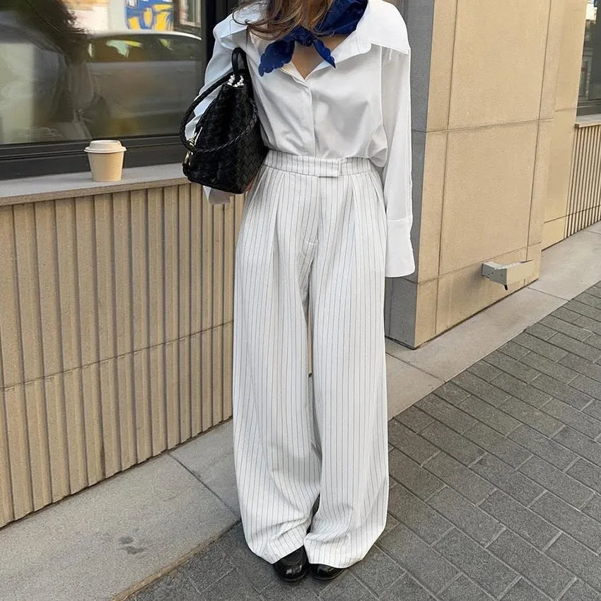White striped wide-leg loose fit women's trousers with a zip fastening on a mannequin
