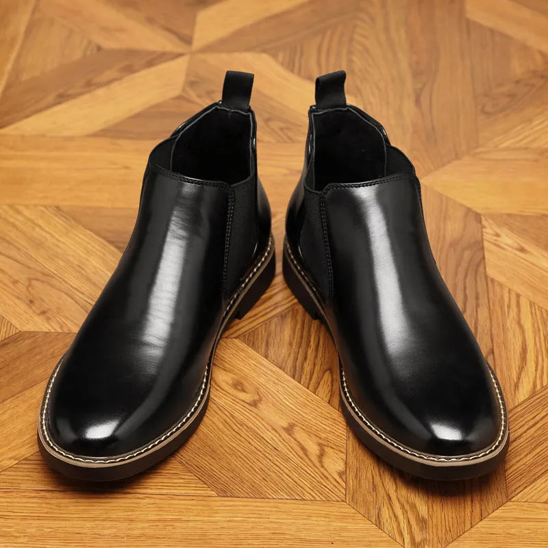 Formal black pointed-toe leather boots with a square heel and rubber sole on a plain background.