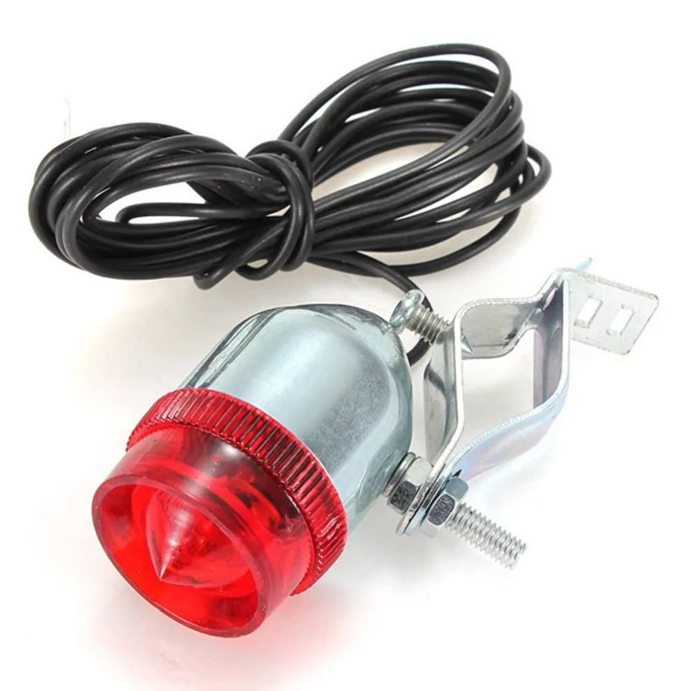 Silver bicycle dynamo generator light kit mounted on a bike fork, with wires for headlight and tail light connections.