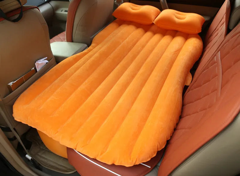 Universal inflatable car bed with flocking material, shown with pump, pillows, and storage bag.