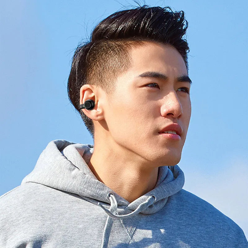 Black wireless Bluetooth clip-on bone conduction earphones with charging cable