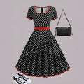 Women's multicolor polka dot dress with square collar, short sleeves, front zipper, and pleated mid-length skirt.