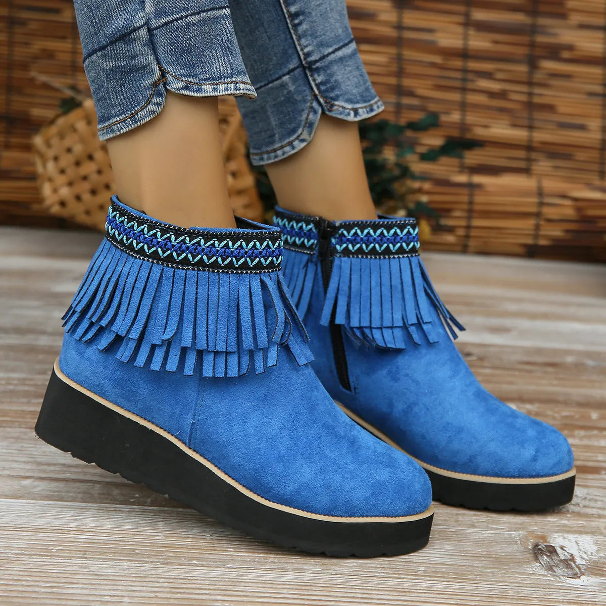 Women's dark brown suede wedge ankle boots with a side zip and decorative tassel.