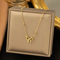 Gold titanium steel bow necklace with cross chain design, adjustable 41-50cm length